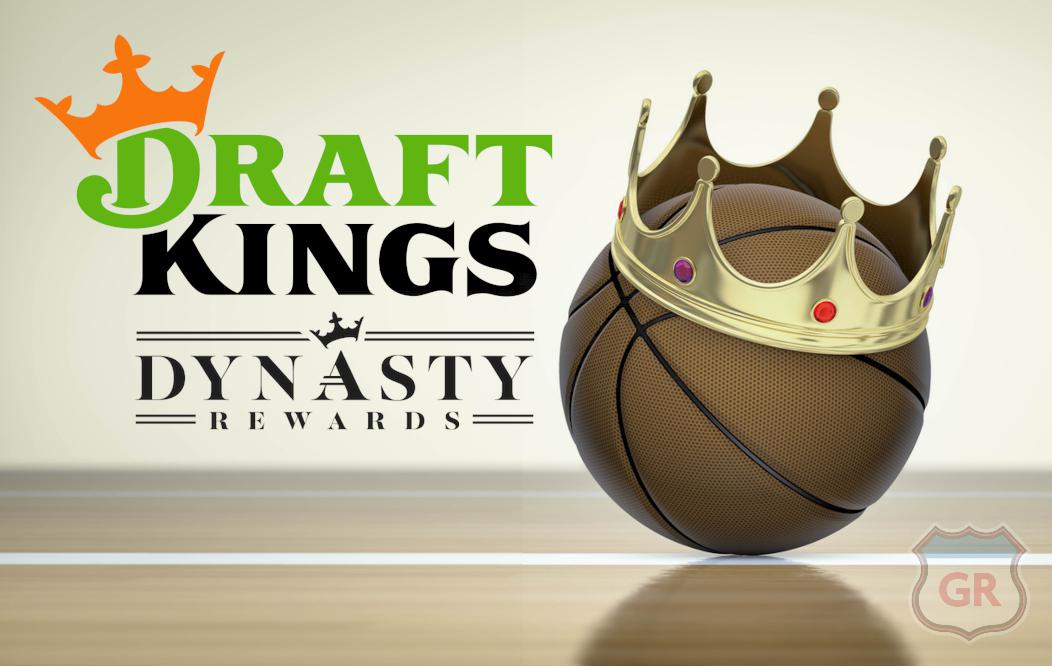 a basketball sitting on the floor of a basketball court. on top of the ball is a gold crown, slightly askew. On the left side is the DraftKings Sportsbook logo and beneath that is the Dynasty Rewards logo.